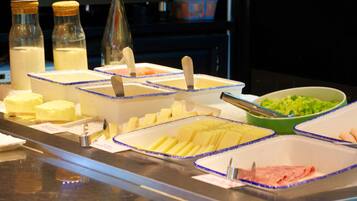 A buffet with various food items and condiments.
