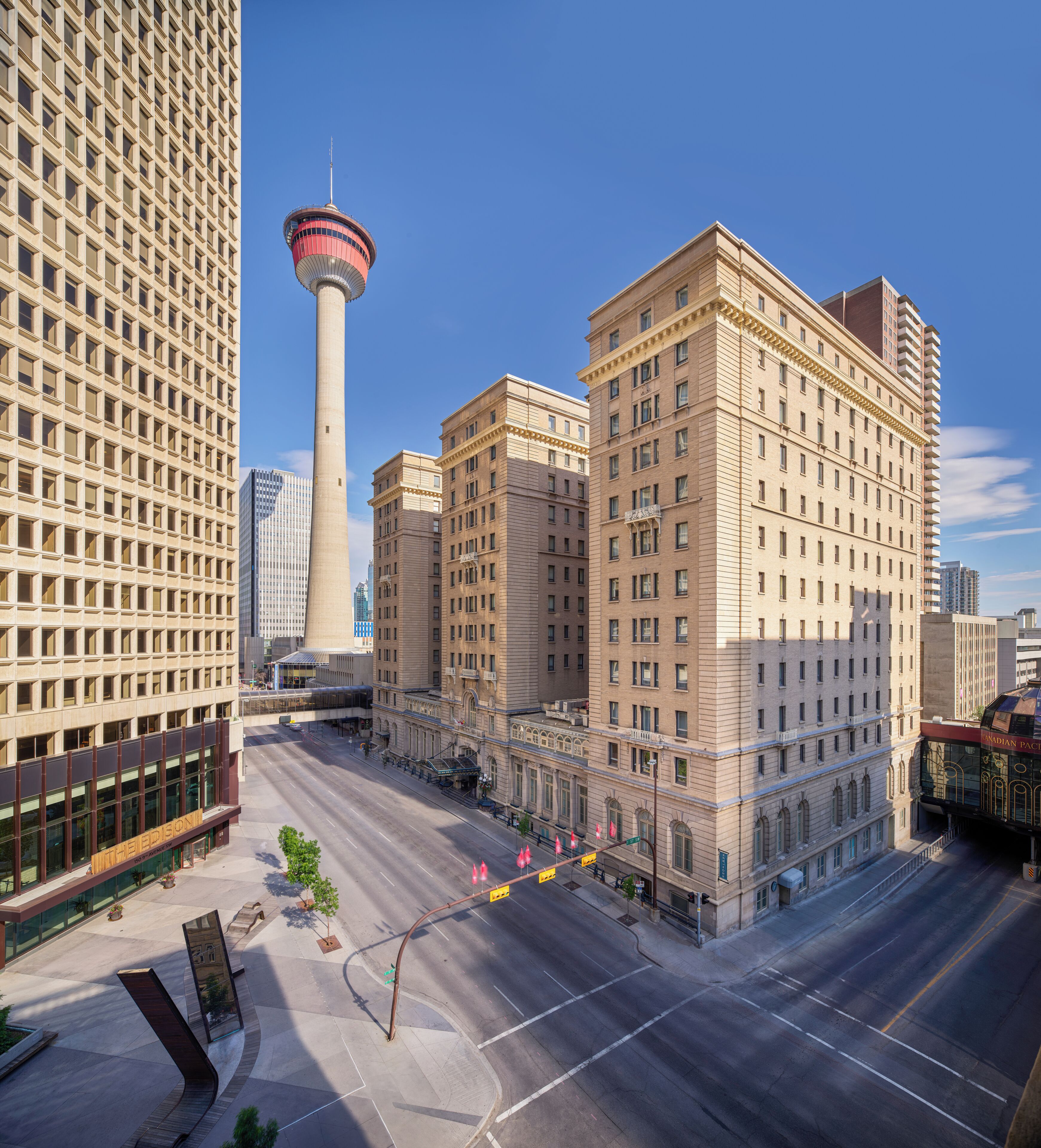 A cityscape with a prominent tower, a variety of buildings, and a clear sky.