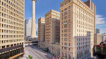 A cityscape with a prominent tower, a variety of buildings, and a clear sky.