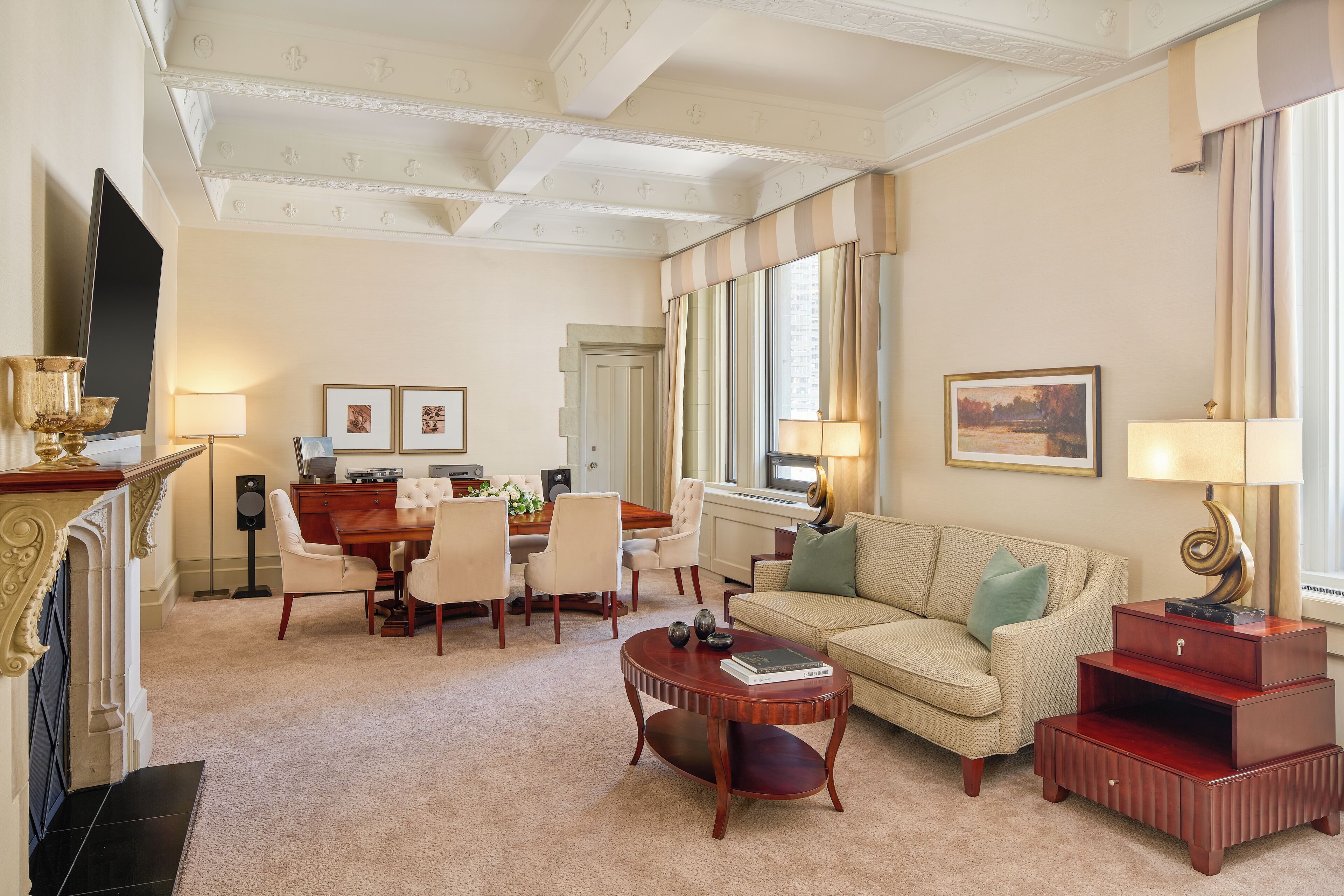 A spacious living room with a fireplace, a dining area, and a sofa.