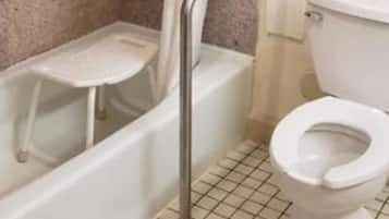 A bathroom with a bathtub, shower, and toilet.