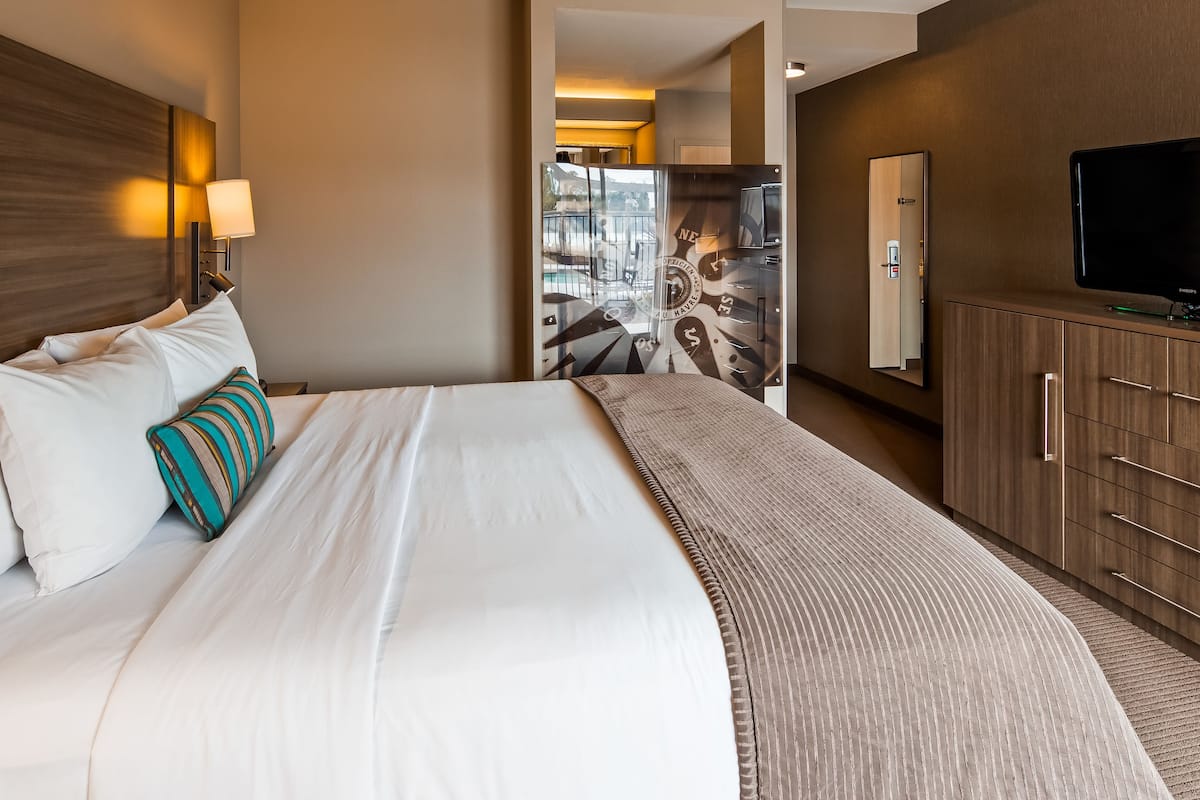 traditional room, 1 king bed, water view | in-room safe, desk, blackout curtains, iron/ironing board