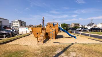 Children can play on the slide and climb the structure in this playground.