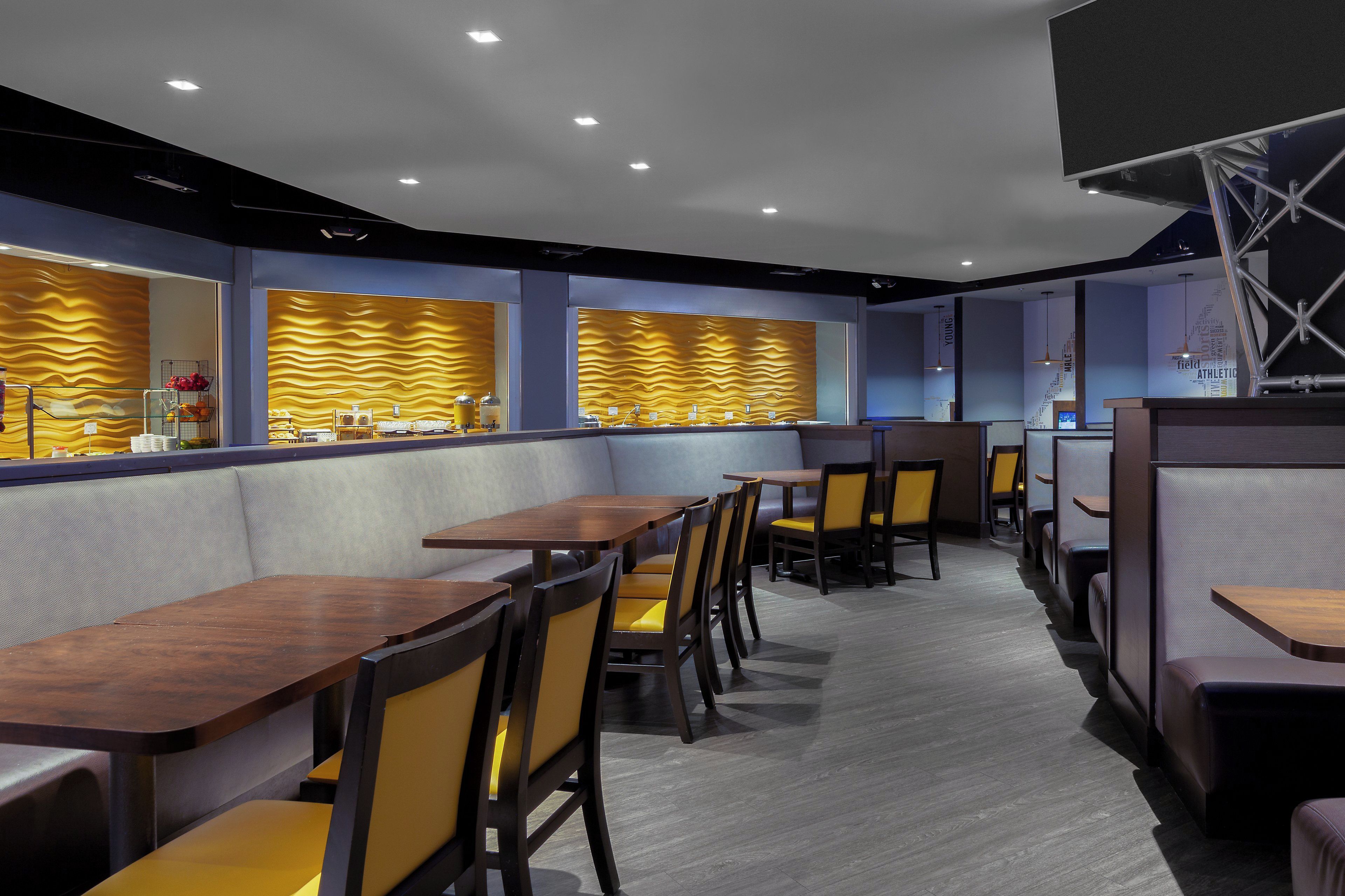 A restaurant interior with booths, tables, and a counter area.