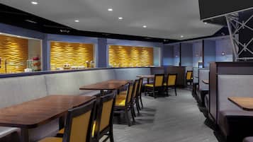 A restaurant interior with booths, tables, and a counter area.