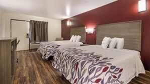 A hotel room with two beds, a desk, and a wardrobe. - Red Roof Inn Crestview (Crestview)