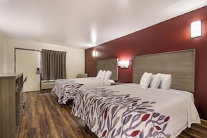 A hotel room with two beds, a desk, and a wardrobe. - Red Roof Inn Crestview (Crestview)
