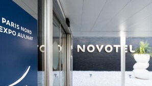 A hotel entrance with a glass door, a checkered floor, and a sign for 'NOVOTEL.' - Novotel Paris Nord Expo Aulnay Hotel (Aulnay-sous-Bois)
