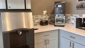A kitchenette with a stainless steel refrigerator, a water dispenser, a coffee machine, and a toaster. - Baymont by Wyndham Great Falls City Center (Great Falls)