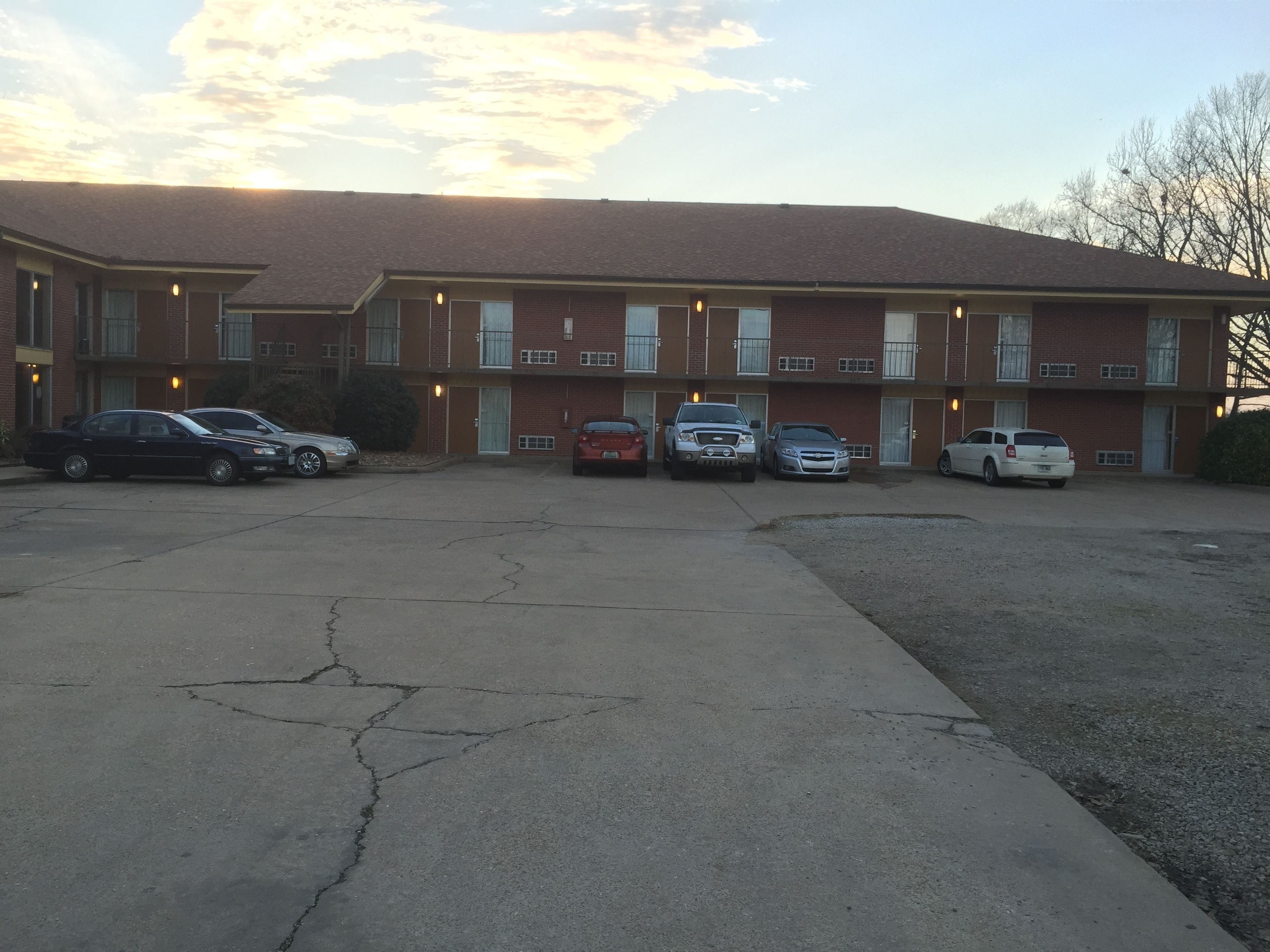 A multi-story building with a parking lot.