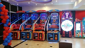 A row of arcade basketball machines labeled "Super MVP" with digital score displays.