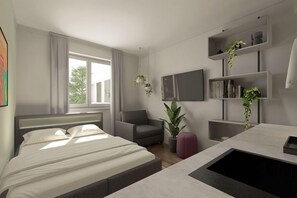 A modern hotel room with a bed, a chair, a TV, and a desk with a sink. - Luxor Hotel (Frankfurt)