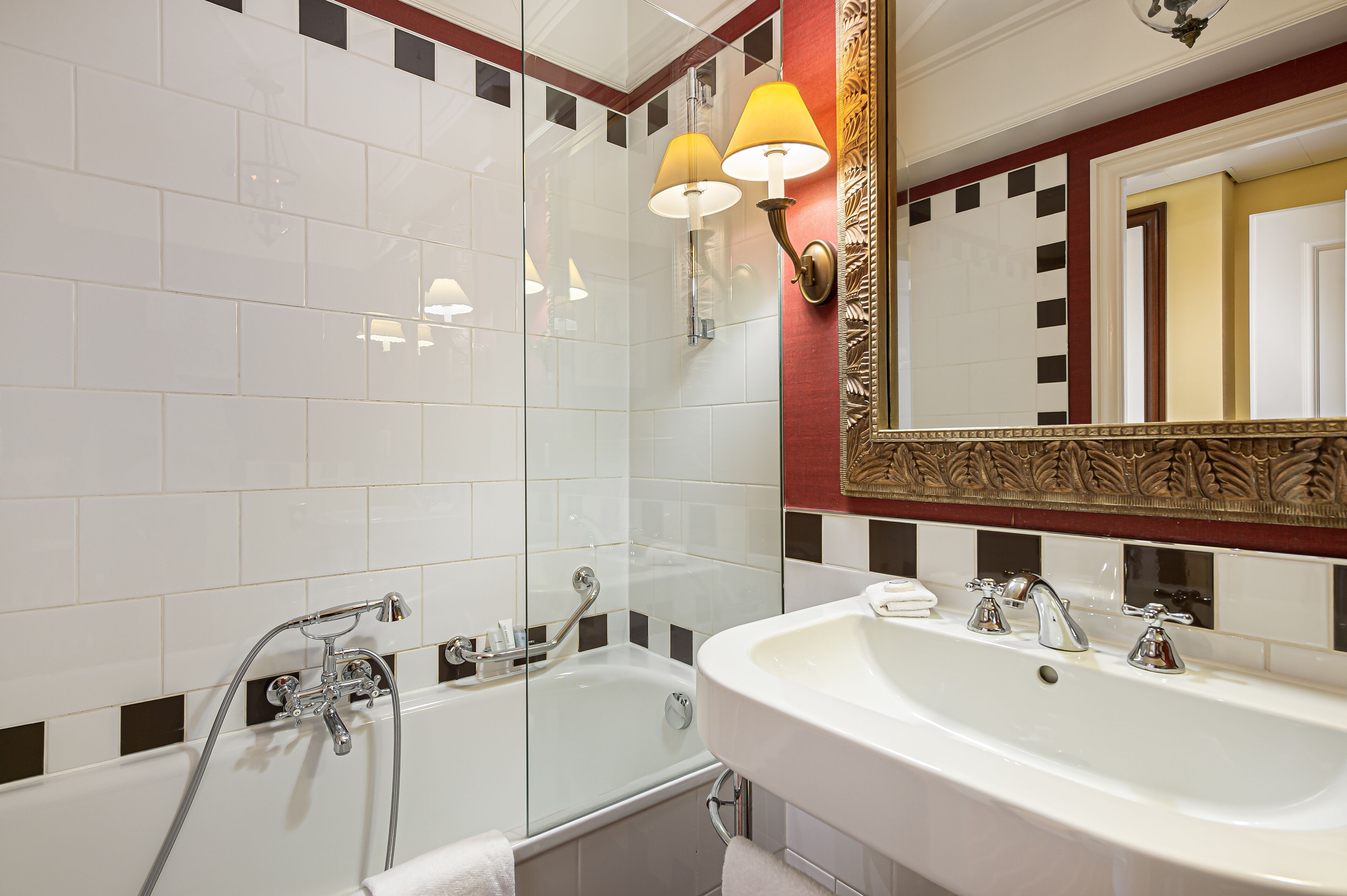 A bathroom with a bathtub, a sink, and a shower.