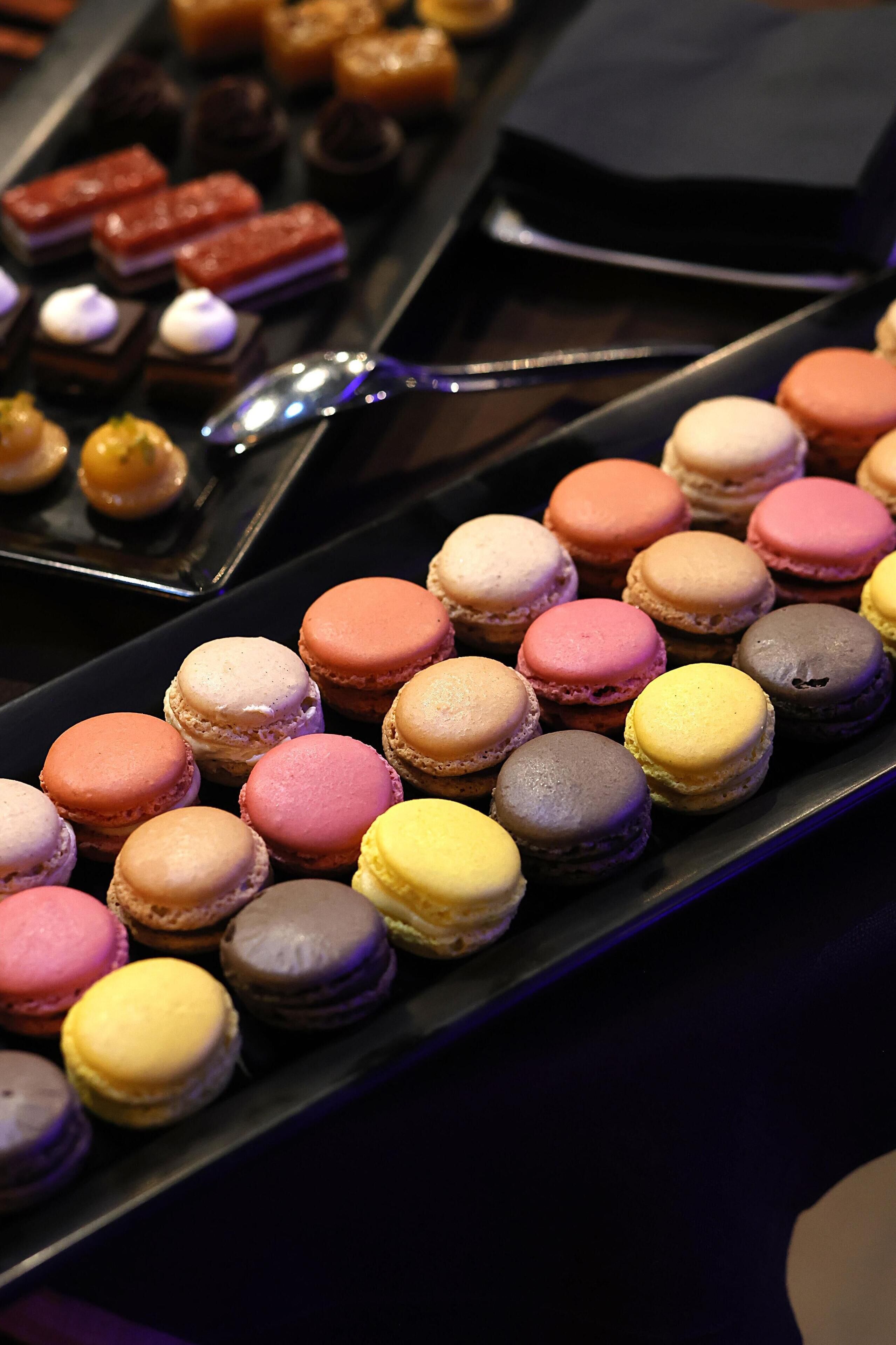 A variety of macarons arranged on a tray.