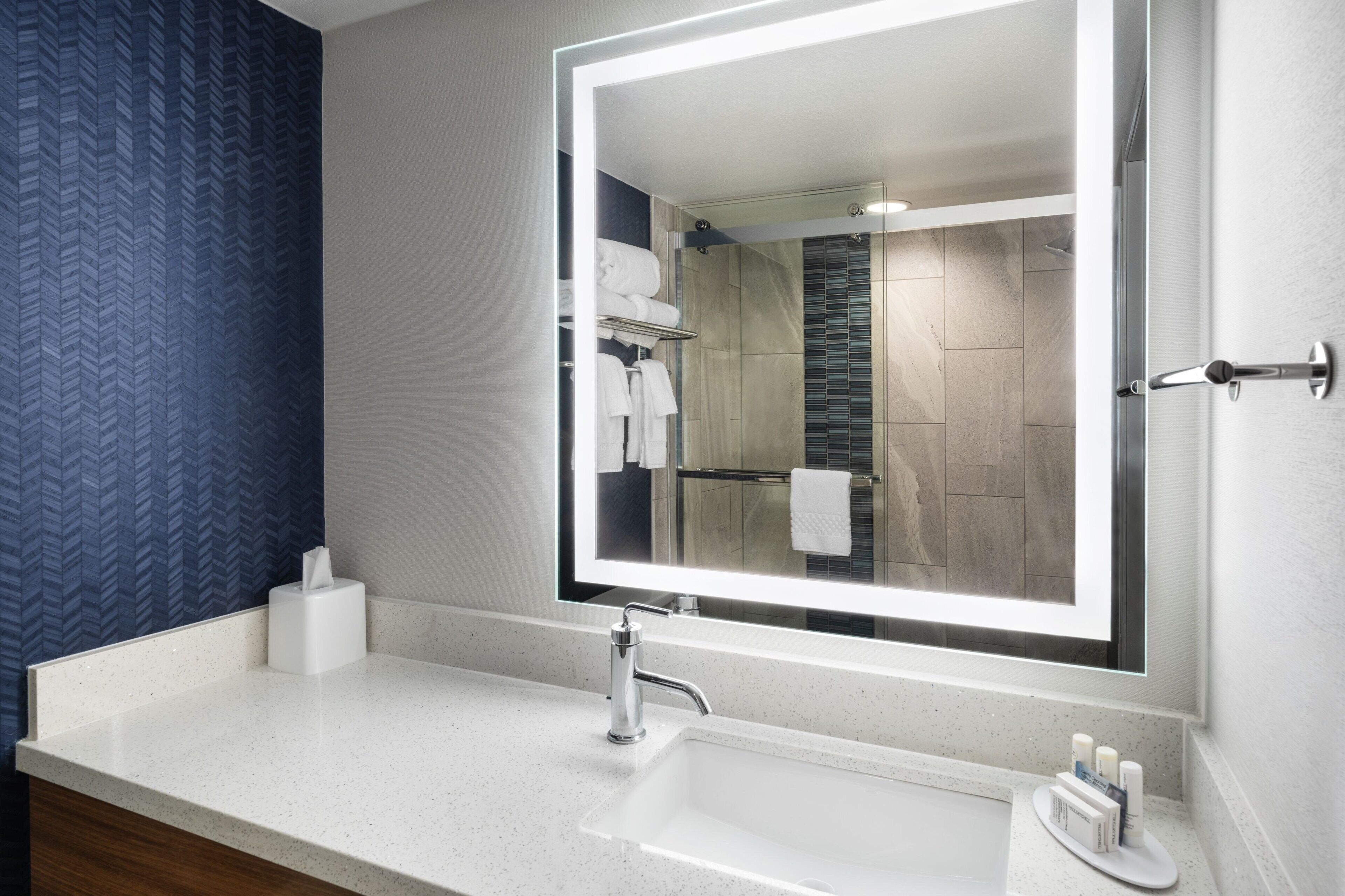 rainfall showerhead, designer toiletries, hair dryer, towels