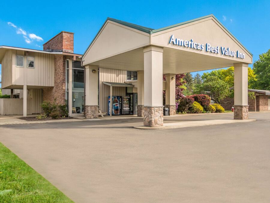 A two-story building with a sign reading "Americas Best Value Inn".