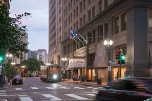 A street view with a tram, a building with a 'Hampton Inn & Suites' sign, and a 'No Parking' sign. - Hampton Inn & Suites New Orleans Downtown (French Qtr Area) (New Orleans)