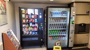 Two vending machines, one with snacks and the other with beverages, in a commercial setting. - Red Roof Inn Greensboro Coliseum (Greensboro)