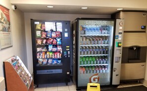 Two vending machines, one with snacks and the other with beverages, in a commercial setting. - Red Roof Inn Greensboro Coliseum (Greensboro)