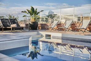 Outdoor pool, open 10:00 AM to 8:00 PM, pool umbrellas, pool loungers