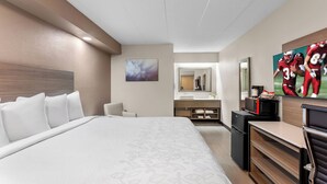A hotel room with a large bed, a desk, a microwave, and a TV. - Red Roof Inn PLUS+ Chicago - Hoffman Estates (Hoffman Estates)