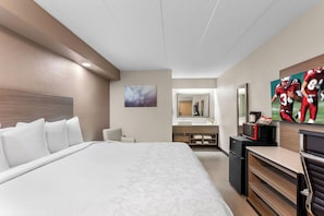 A hotel room with a large bed, a desk, a microwave, and a TV. - Red Roof Inn PLUS+ Chicago - Hoffman Estates (Hoffman Estates)