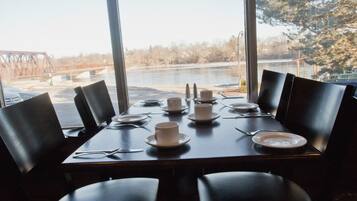 Enjoy meals with a view of the water and bridge from this dining area.