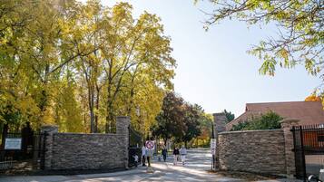 A gated entrance with stone walls and a clear sky.