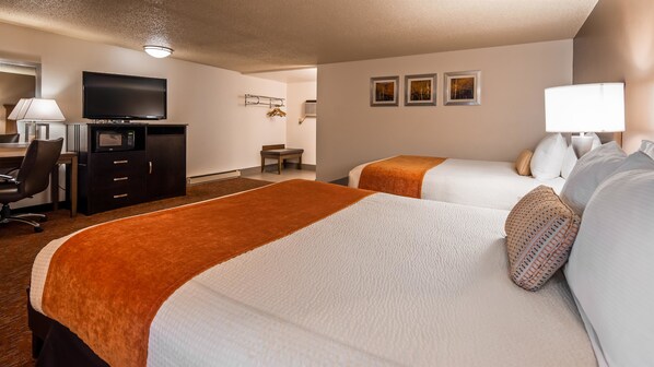 A hotel room with two beds, a desk with a chair, a television, and a microwave.