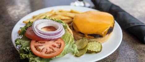 A plate with a hamburger, fries, and a salad.