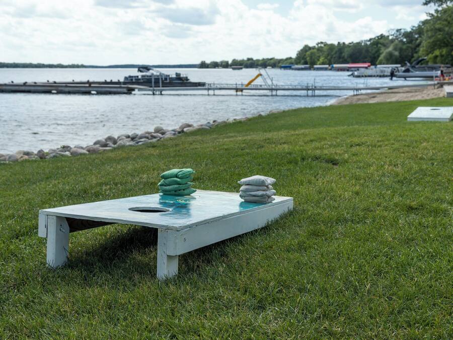 A grassy area with a white table and two stacks of green and white objects.