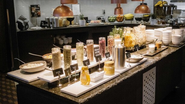 A breakfast buffet with various food items and condiments. - Radisson Blu Arlandia Hotel (Arlanda)