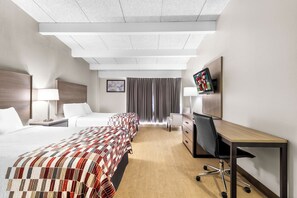 A hotel room with a large bed, a desk with a chair, a TV, and a window with curtains. - Red Roof Inn Niagara Falls (Niagara Falls)
