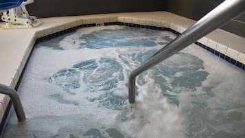 Relax in a hot tub surrounded by a decorative border.