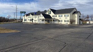 A two-story building with a sign reading "Quality Inn" and "Indoor Pool".