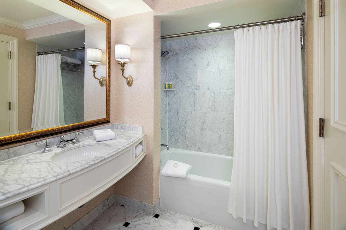 combined shower/bathtub, designer toiletries, hair dryer, bathrobes