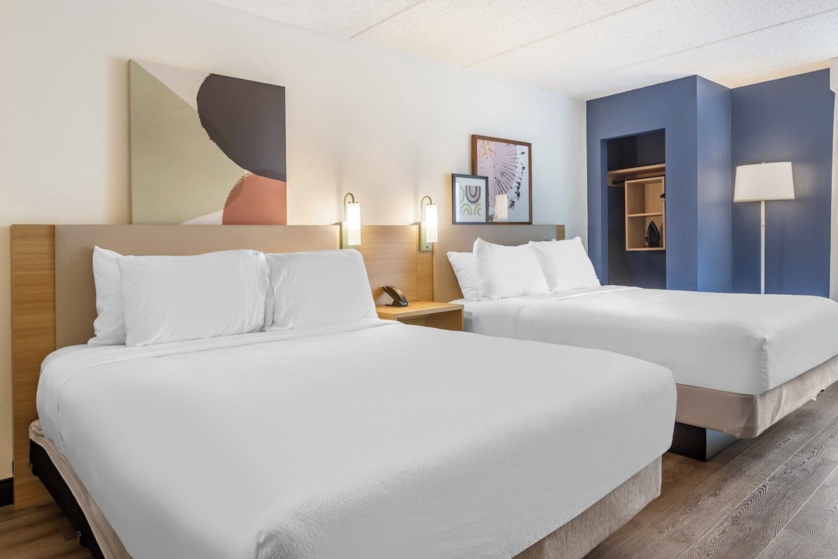 Premium bedding, desk, laptop workspace, blackout curtains