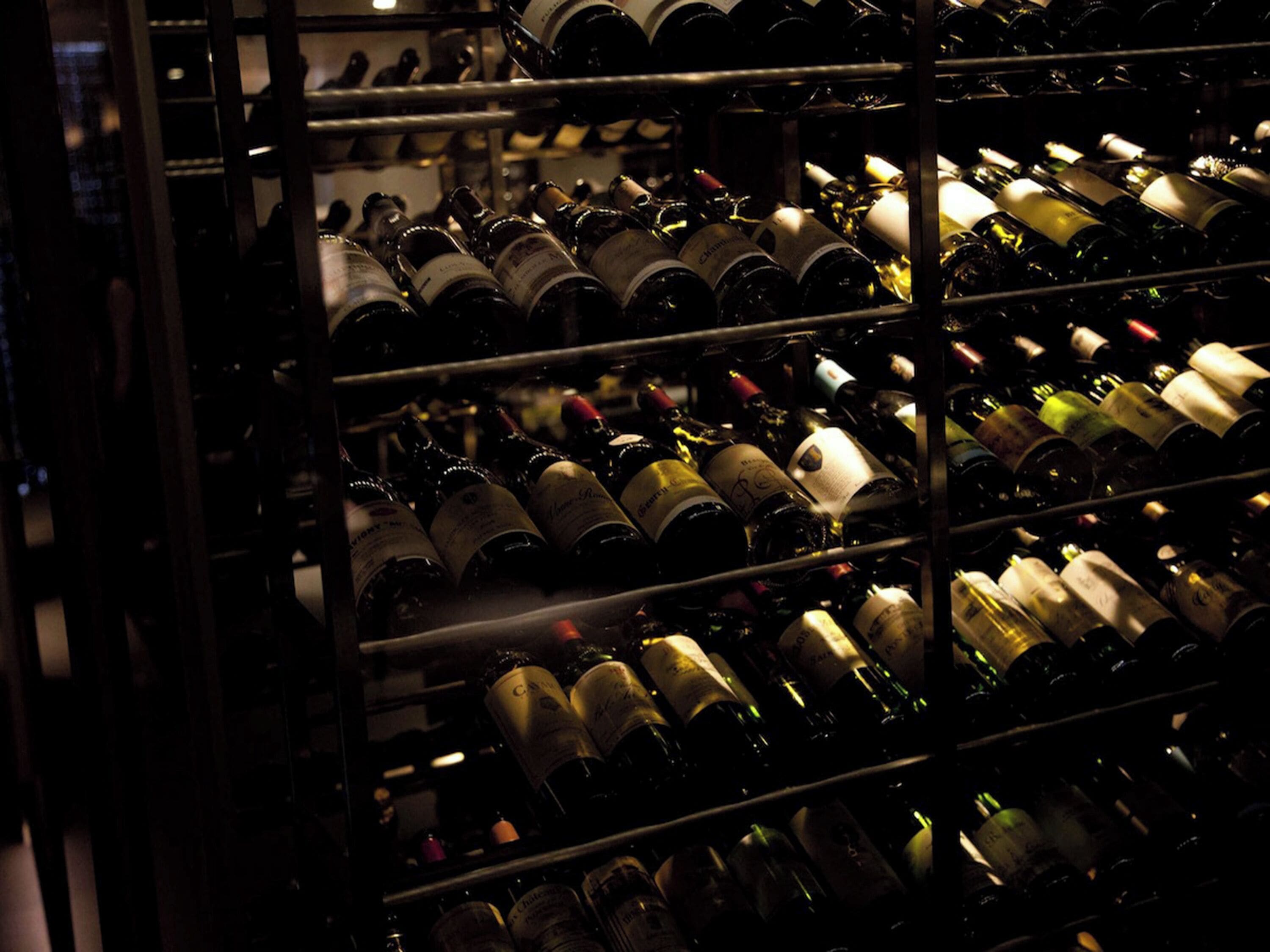A wine rack with multiple bottles.