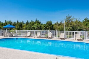 Seasonal outdoor pool, open 10:00 AM to 8:00 PM, pool umbrellas