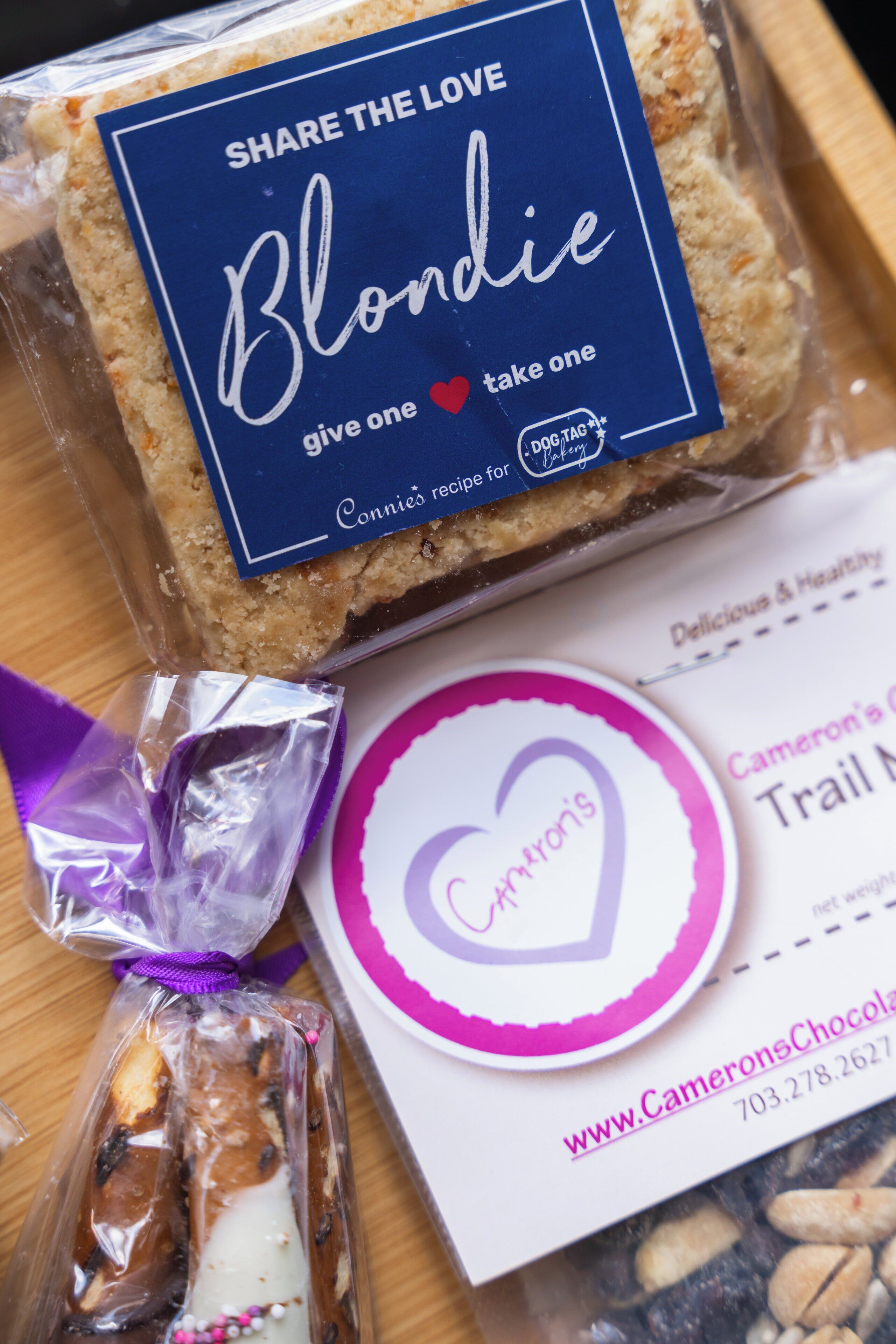 A package with a blue label that reads "Share the Love Blondie" and a website address "www.CameronsChocolate.com".