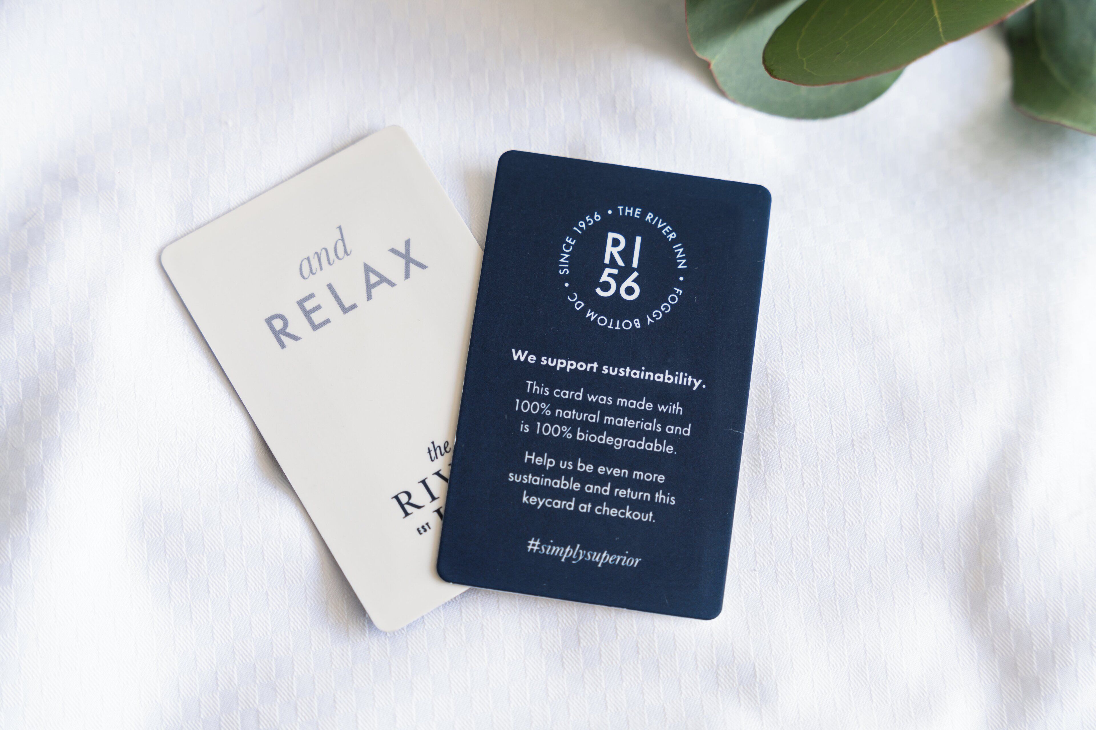Two cards, one white and one dark blue, with text promoting sustainability and biodegradability.