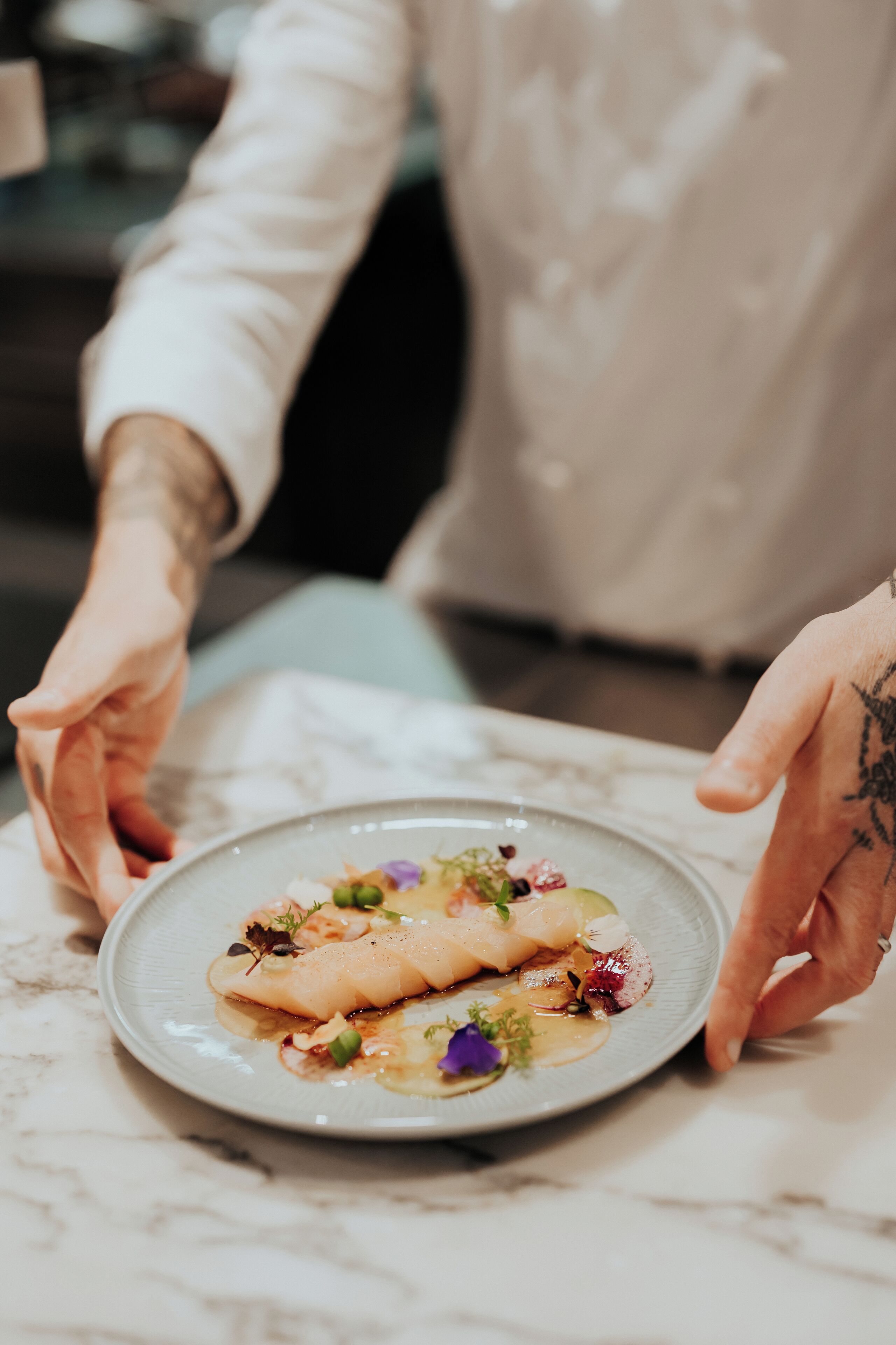A person serving a dish on a plate.