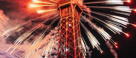 A tower with fireworks in the background.