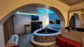 Suite, 1 King Bed, Non Smoking, Jetted Tub | Desk, laptop workspace, blackout curtains, iron/ironing board