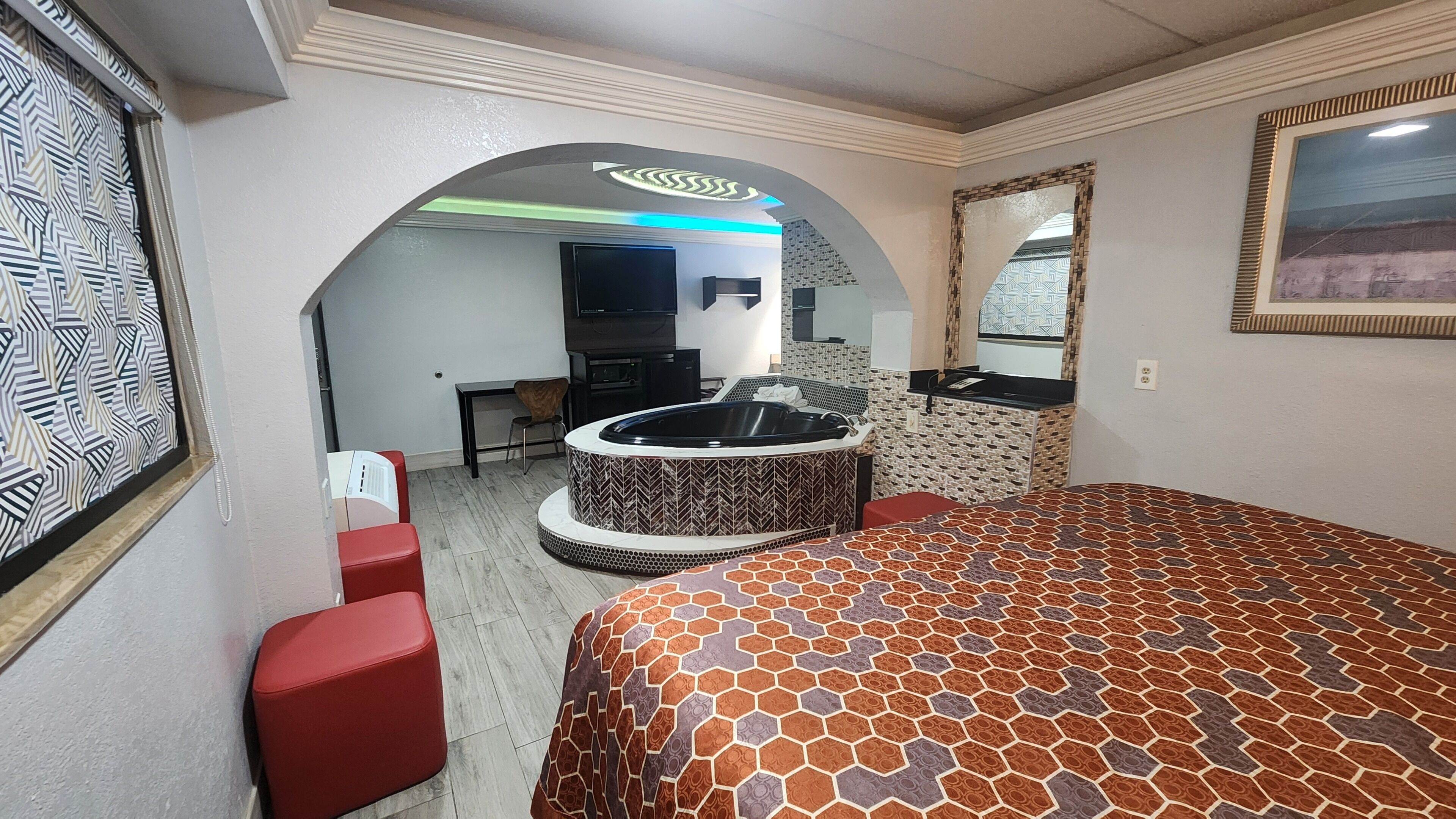 Suite, 1 King Bed, Non Smoking, Jetted Tub | Desk, laptop workspace, blackout drapes, iron/ironing board