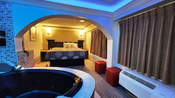 Suite, 1 King Bed, Non Smoking, Jetted Tub | Desk, laptop workspace, blackout drapes, iron/ironing board