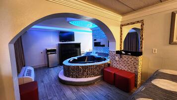 Suite, 1 King Bed, Non Smoking, Jetted Tub | Desk, laptop workspace, blackout curtains, iron/ironing board