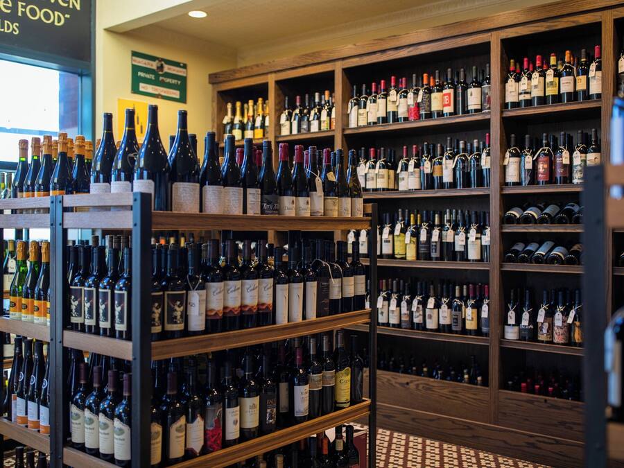 A wine cellar with multiple shelves stocked with various wine bottles.