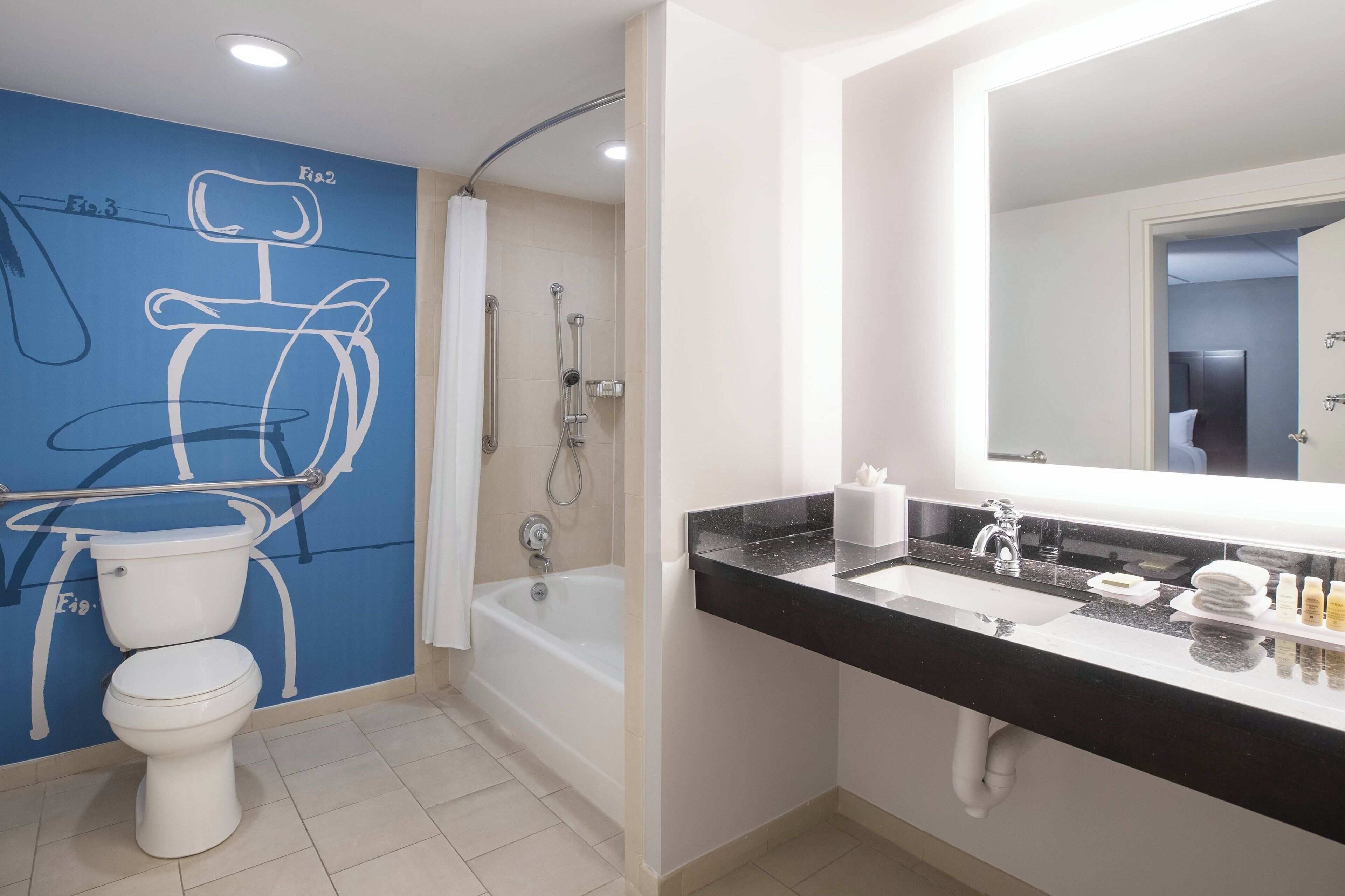 designer toiletries, hair dryer, towels