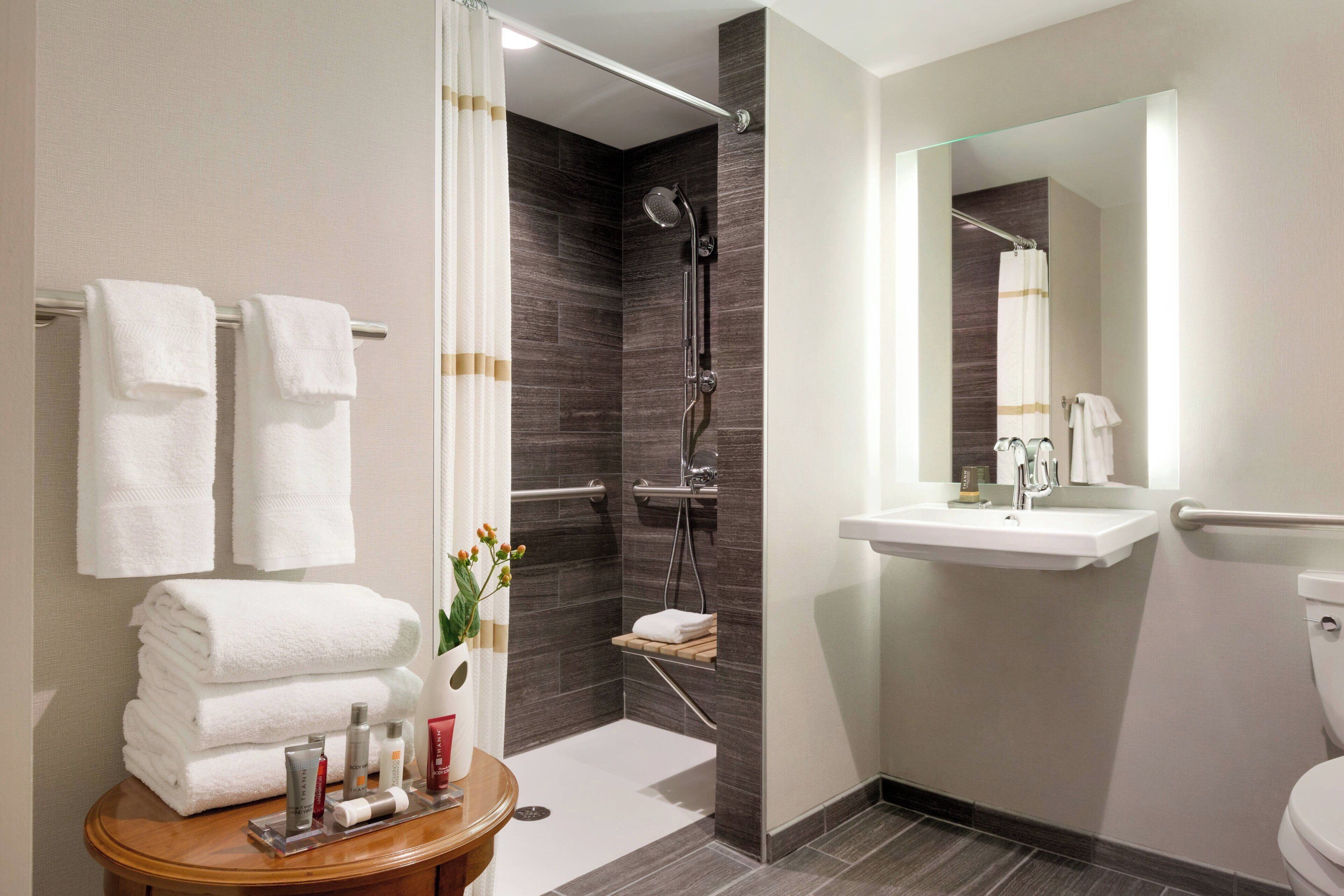 designer toiletries, hair dryer, towels